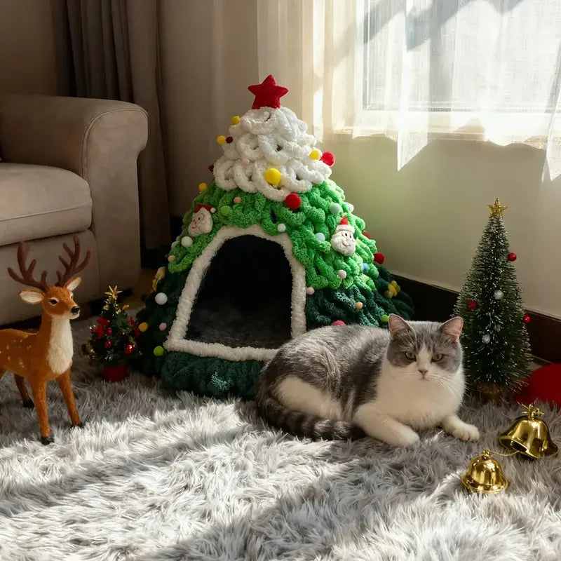 Cat resting next to the green Christmas tree cat bed